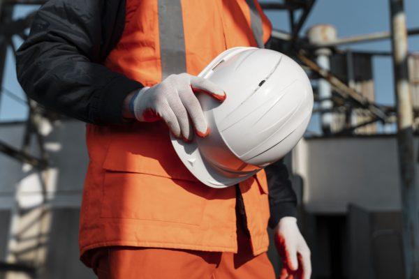 close up hand holding safety helmet 600x400